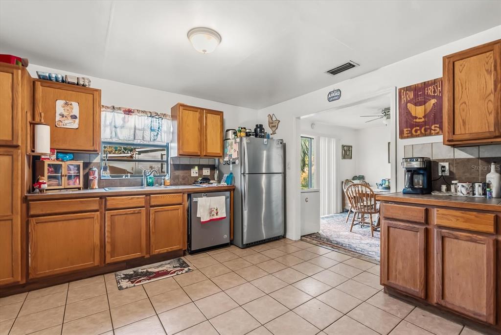 418 Glenn Road Orlando, FL 32833 - Photo 18 of 27 a kitchen with stainless steel appliances granite countertop a refrigerator and a stove top oven