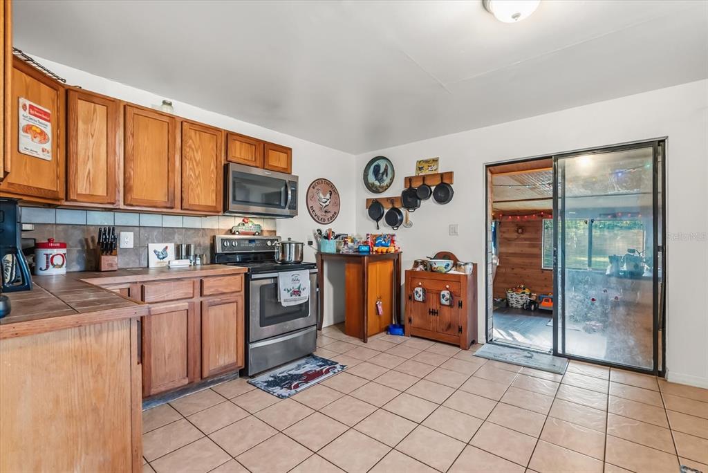 418 Glenn Road Orlando, FL 32833 - Photo 19 of 27 a kitchen with stainless steel appliances granite countertop a refrigerator and a stove top oven