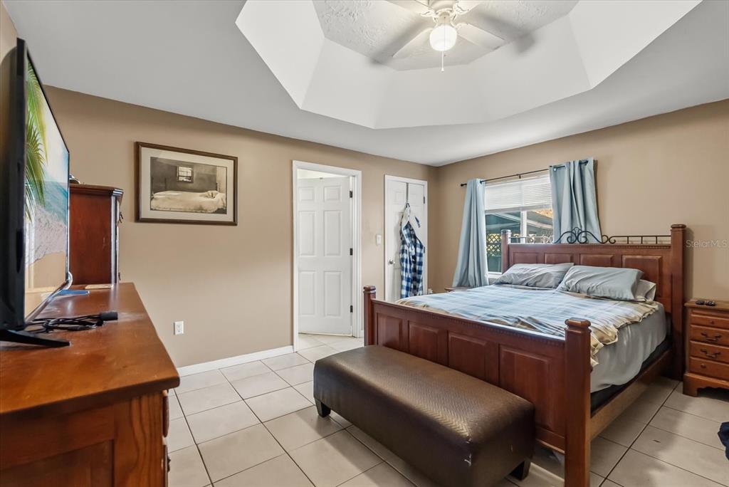 418 Glenn Road Orlando, FL 32833 - Photo 7 of 27 a bedroom with a bed and a desk