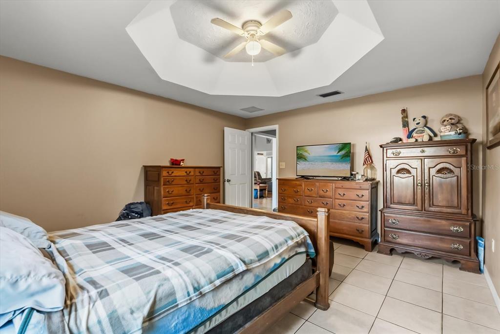 418 Glenn Road Orlando, FL 32833 - Photo 8 of 27 a bedroom with a bed and a chandelier