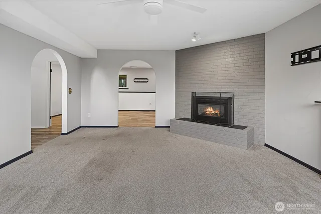 a view of empty room with a fireplace