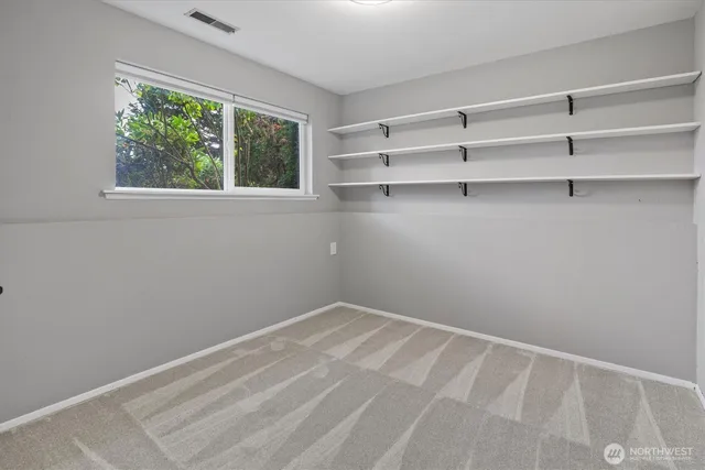 a view of a room with shelf on the wall