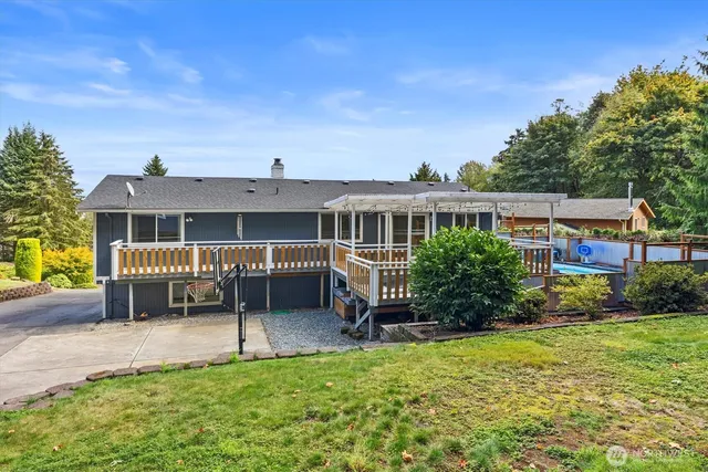 a view of a house with backyard porch and sitting area