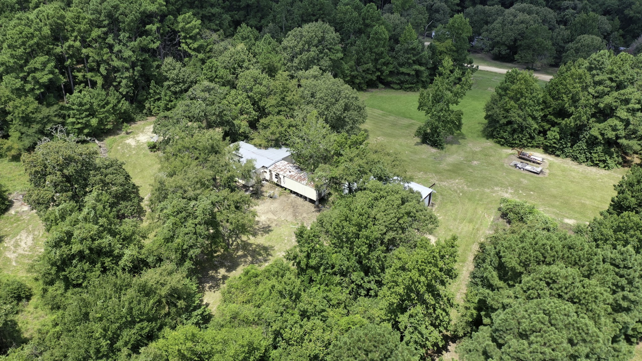 8374 Cattle Trail Road Midway, TX 75852 - Photo 7 of 16 an aerial view of residential house with outdoor space and trees all around