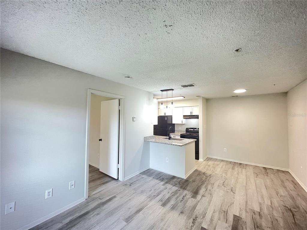 241 Afton Square, Unit 203 Altamonte Springs, FL 32714 - Photo 11 of 43 a view of a kitchen with wooden floor and a sink