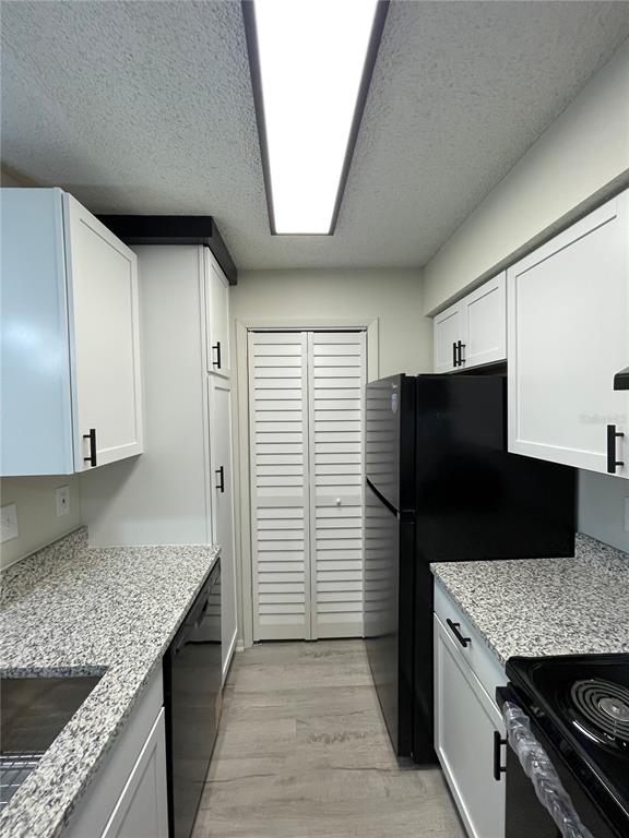 241 Afton Square, Unit 203 Altamonte Springs, FL 32714 - Photo 15 of 43 a kitchen with granite countertop a refrigerator and a sink
