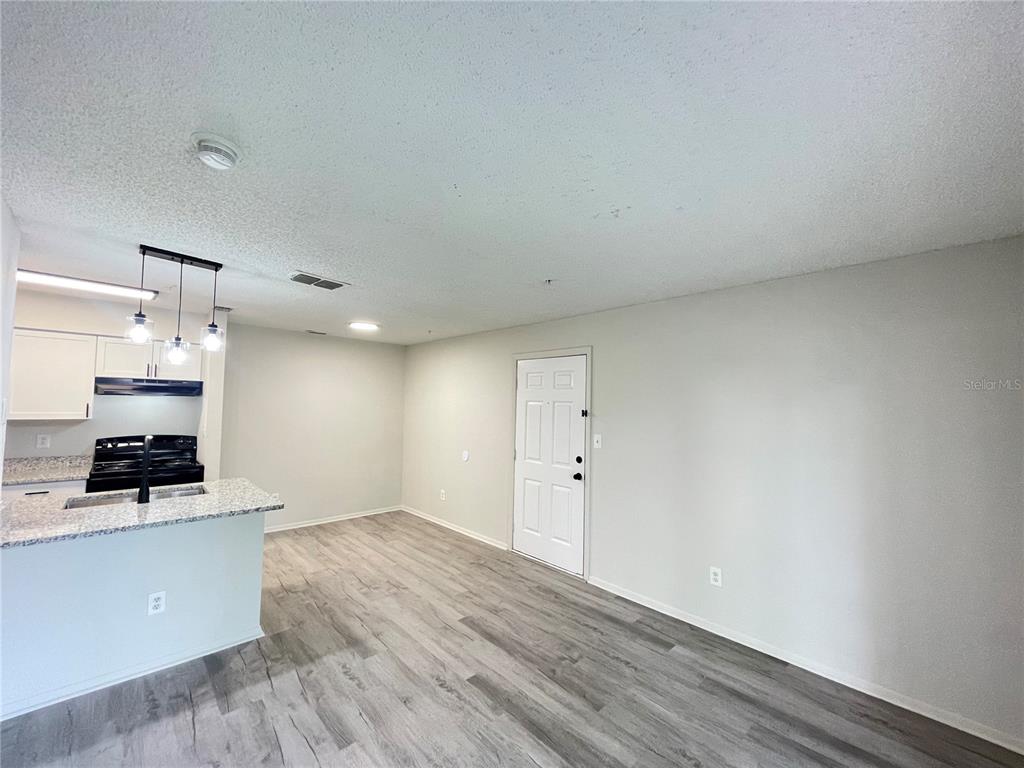 241 Afton Square, Unit 203 Altamonte Springs, FL 32714 - Photo 19 of 43 a view of a kitchen with wooden floor and electronic appliances