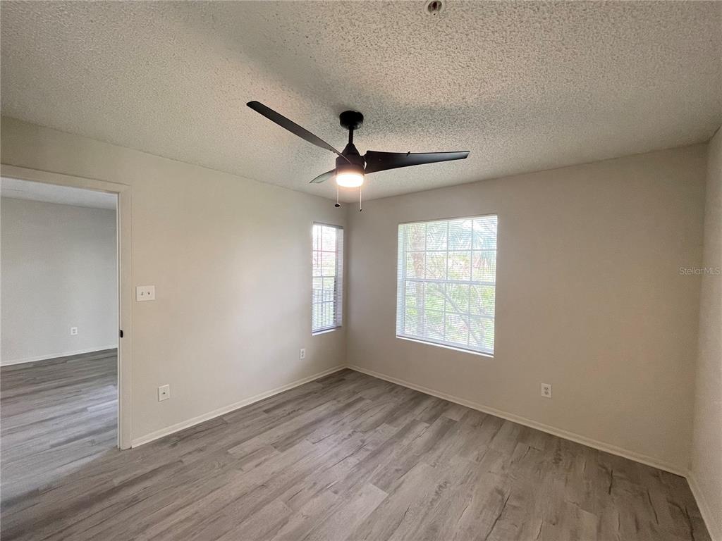 241 Afton Square, Unit 203 Altamonte Springs, FL 32714 - Photo 24 of 43 a view of an empty room with wooden floor and a window