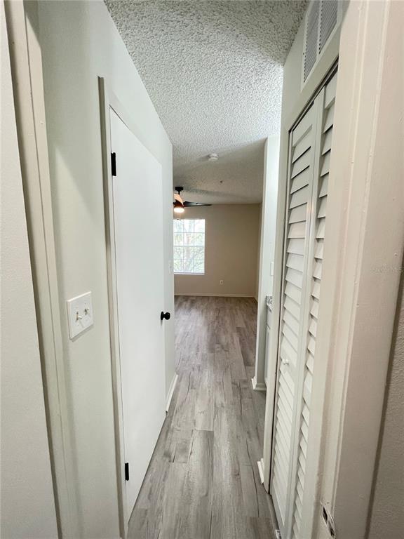 241 Afton Square, Unit 203 Altamonte Springs, FL 32714 - Photo 29 of 43 a view of a hallway with wooden floor and staircase
