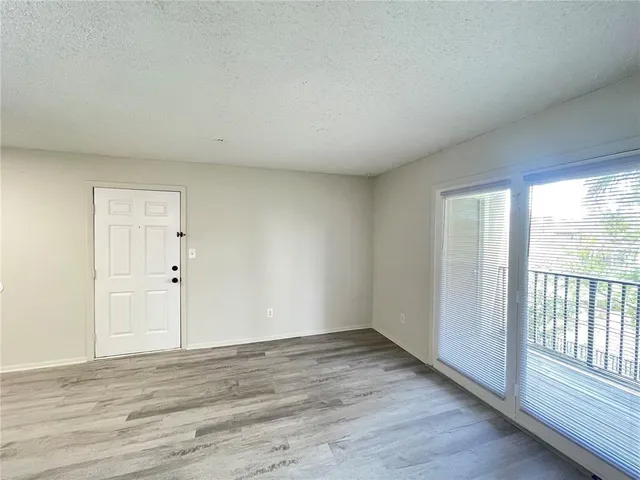 a view of a kitchen with wooden floor and a sink