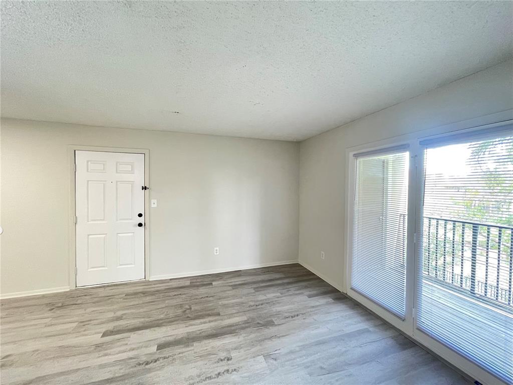 241 Afton Square, Unit 203 Altamonte Springs, FL 32714 - Photo 10 of 43 wooden floor in an empty room with a window