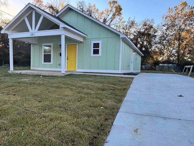 a front view of a house with garden