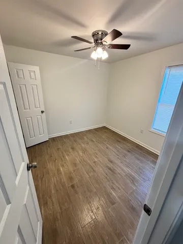 a view of room with hardwood floor and staircase