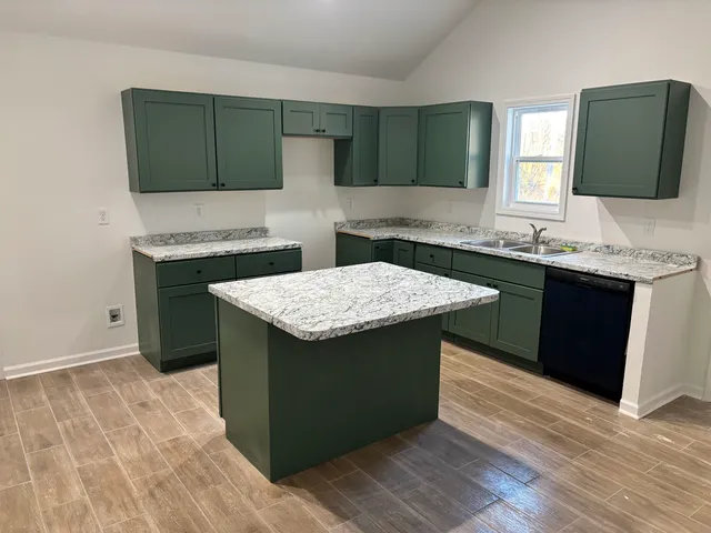 a kitchen with a sink and a stove top oven