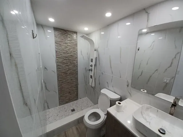 a bathroom with a sink toilet and shower
