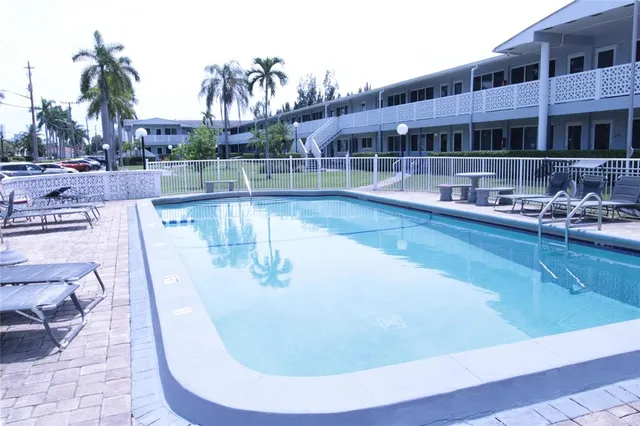 a view of a swimming pool with sitting area