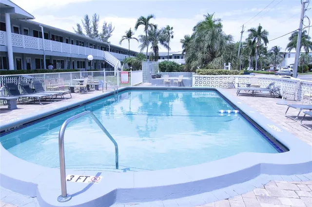 a view of a swimming pool with a lounge chairs