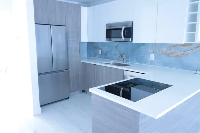 a kitchen with a sink and cabinets
