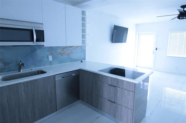 a kitchen with a sink and a microwave
