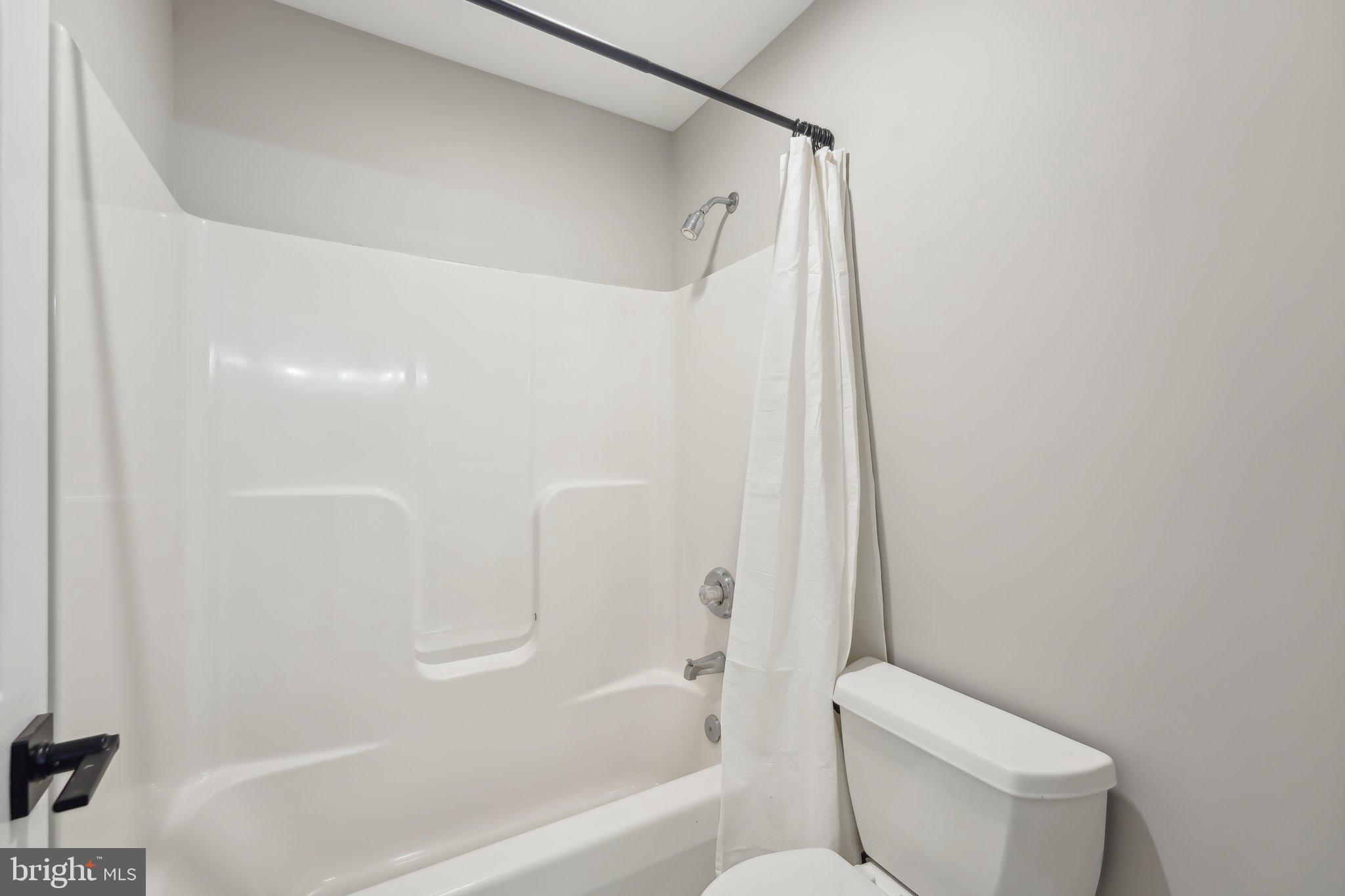 207 Summit Road Mount Laurel, NJ 08054 - Photo 35 of 57 a white toilet sitting next to a bath tub