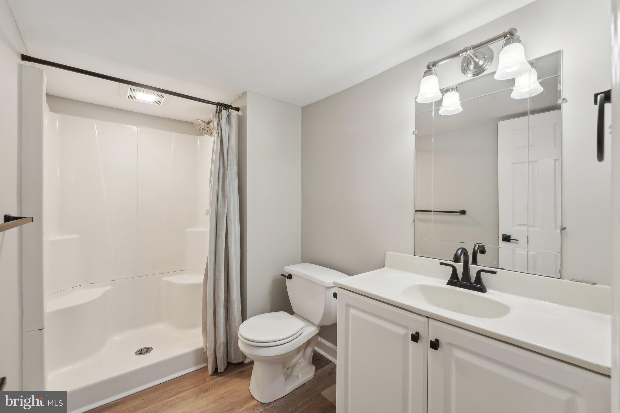 207 Summit Road Mount Laurel, NJ 08054 - Photo 50 of 57 a bathroom with a sink a toilet a mirror and shower
