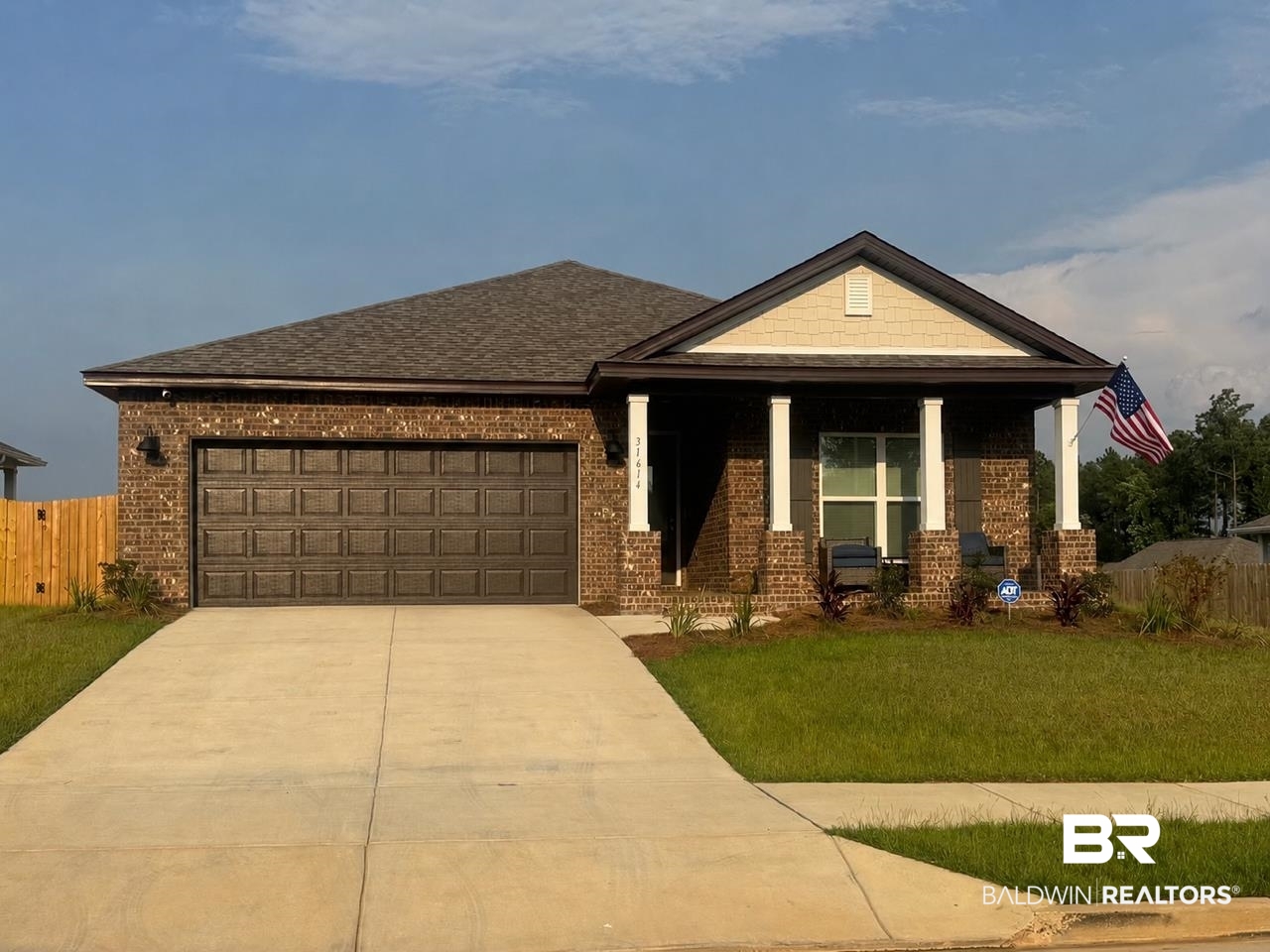 31614 Lyon Road Daphne, AL 36527 - Photo 1 of 48 Brick exterior with a covered front porch featuring white columns and a neutral-toned gable