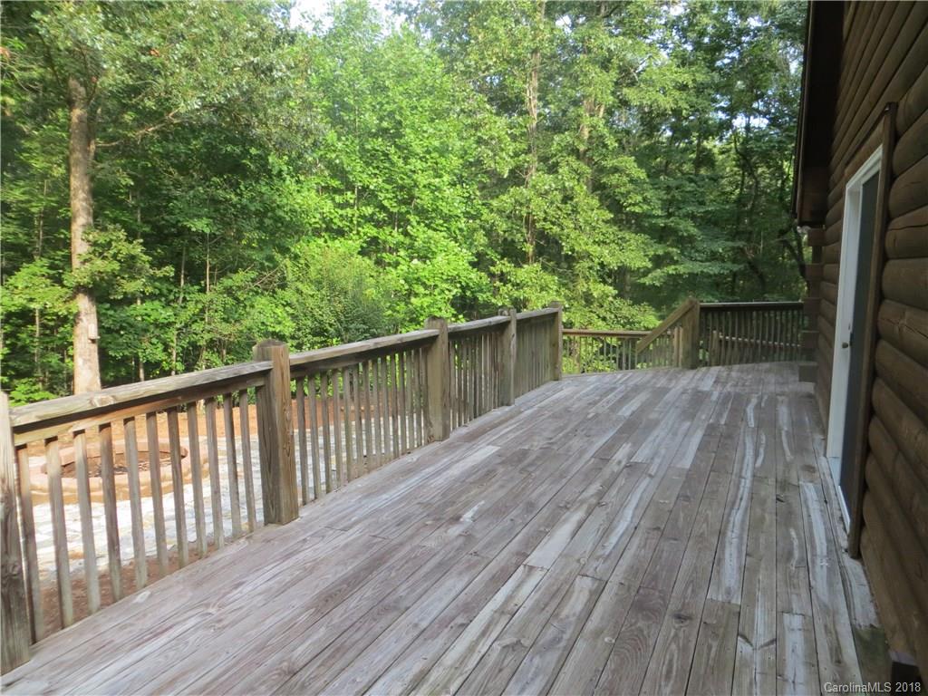 470 River Ridge Parkway Rutherfordton, NC 28139 - Photo 4 of 15 a balcony with wooden floor and trees in the back