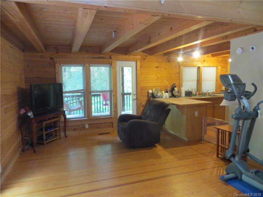 470 River Ridge Parkway Rutherfordton, NC 28139 - Photo 5 of 15 a living room with furniture a flat screen tv and a floor to ceiling window