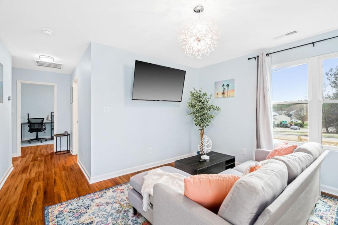 6901 Jeffreys Creek Lane Raleigh, NC 27616 - Photo 18 of 37 a living room with furniture and a chandelier