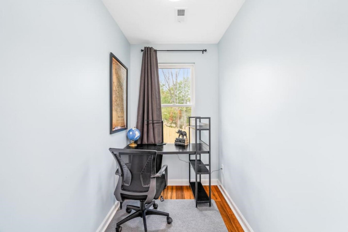 6901 Jeffreys Creek Lane Raleigh, NC 27616 - Photo 22 of 37 a view of a workspace with furniture and a window