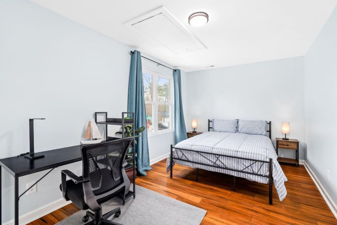 6901 Jeffreys Creek Lane Raleigh, NC 27616 - Photo 27 of 37 a bedroom with a bed windows and wooden floor
