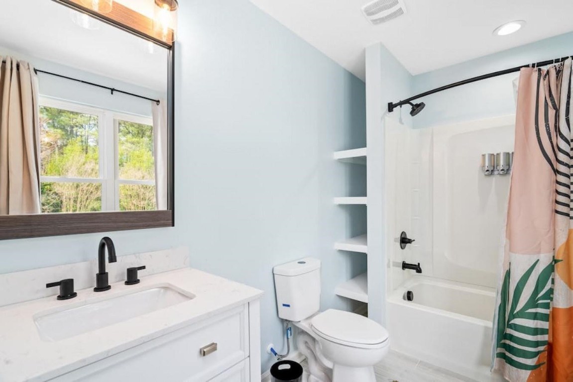 6901 Jeffreys Creek Lane Raleigh, NC 27616 - Photo 29 of 37 a bathroom with a sink a toilet and a large mirror