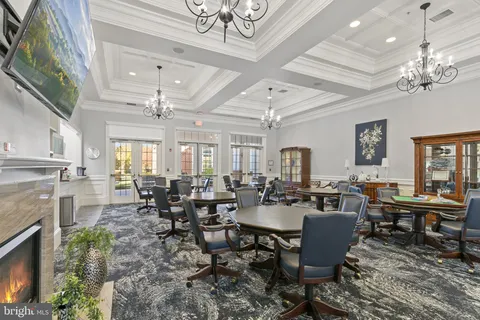 a room with pool table and a chandelier