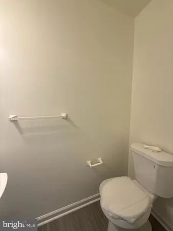 a white toilet sitting next to a shower