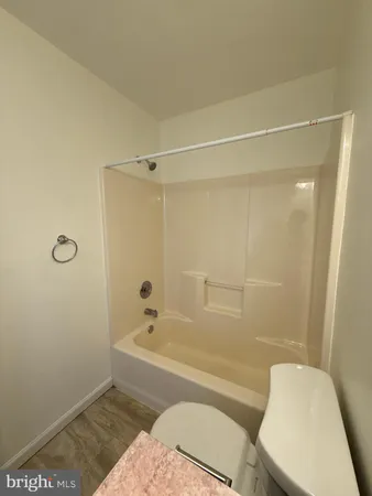 a bathroom with a toilet and shower