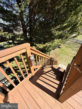 a view of a balcony with wooden floor and fence