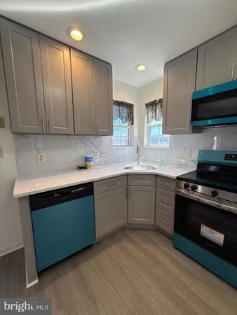 a kitchen with a sink cabinets and a stove