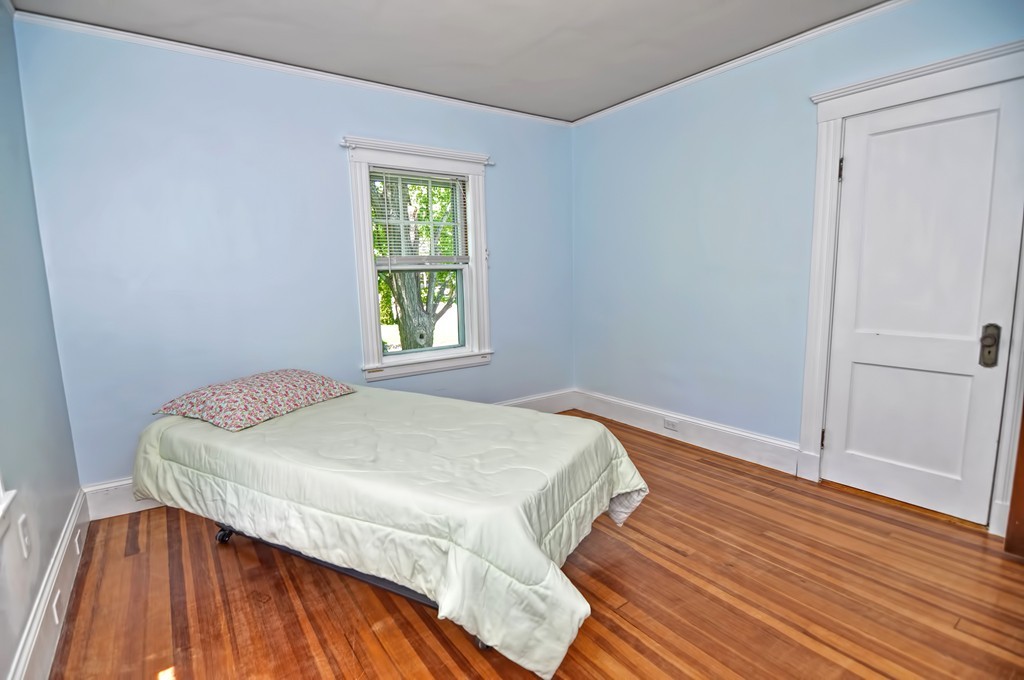 175 Union Street Walpole, MA 02032 - Photo 14 of 29 a bedroom with a bed and a wooden floor
