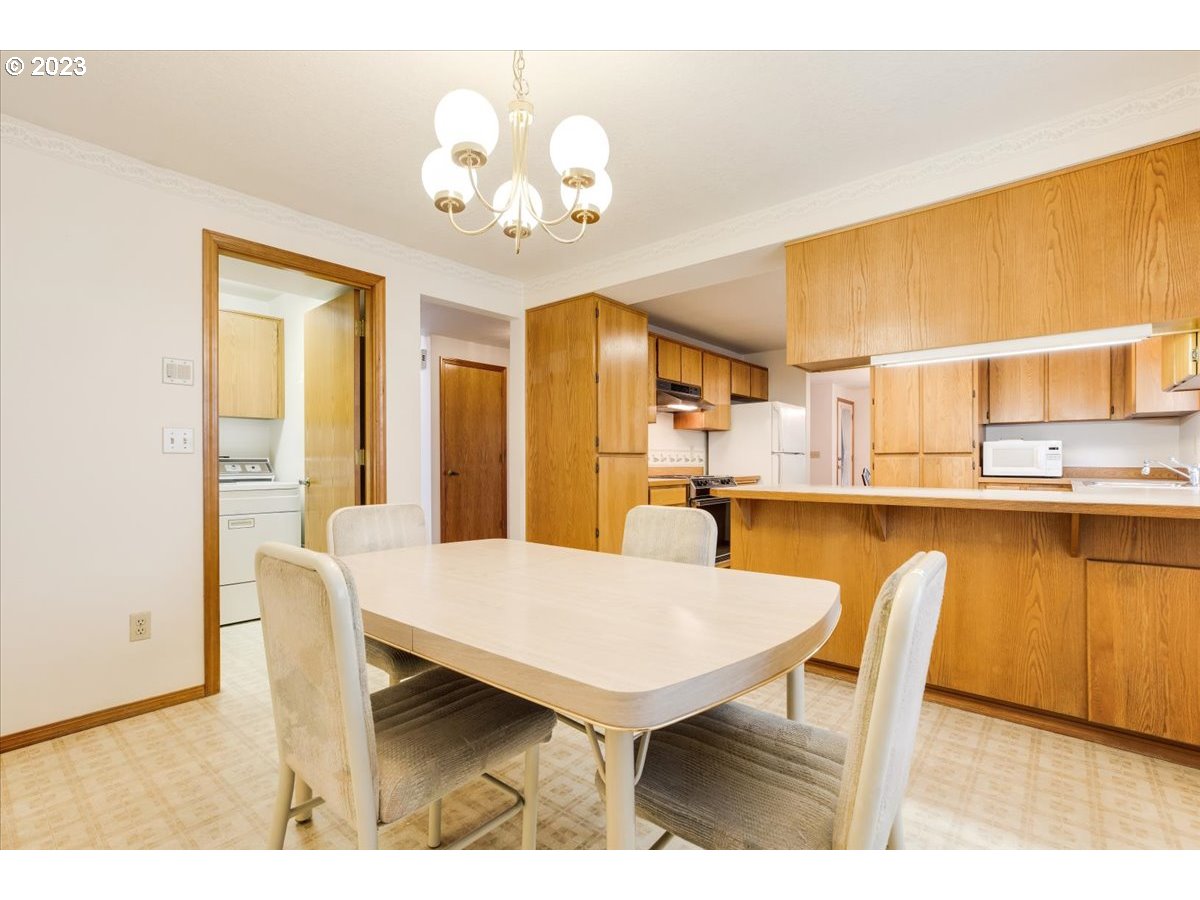 1502 Southeast Elliott Avenue Gresham, OR 97080 - Photo 18 of 37 a view of a dining room with furniture and wooden floor