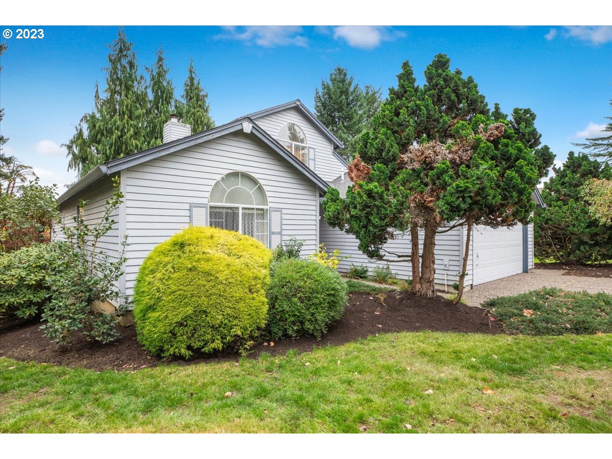 1502 Southeast Elliott Avenue Gresham, OR 97080 - Photo 2 of 37 a view of a backyard with plants and large trees