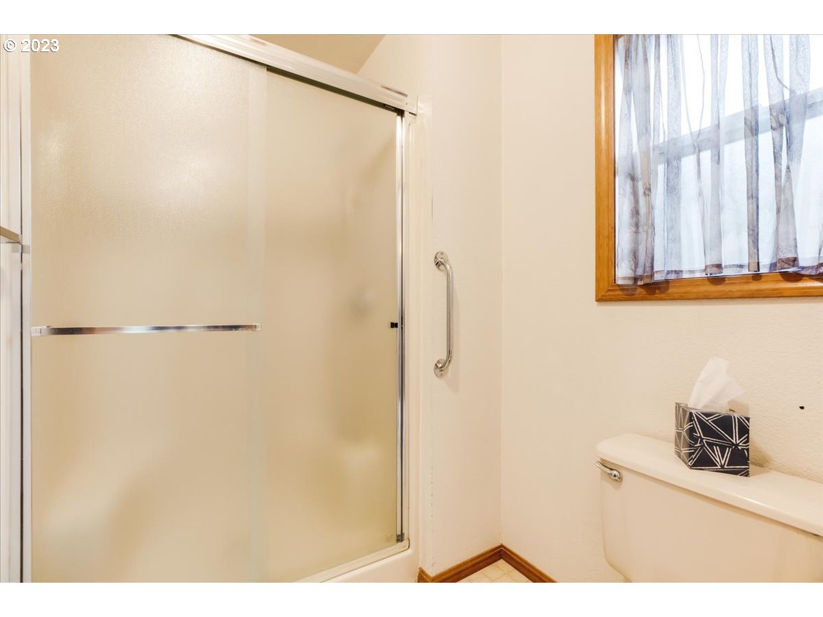 1502 Southeast Elliott Avenue Gresham, OR 97080 - Photo 23 of 37 a bathroom with a shower and a window