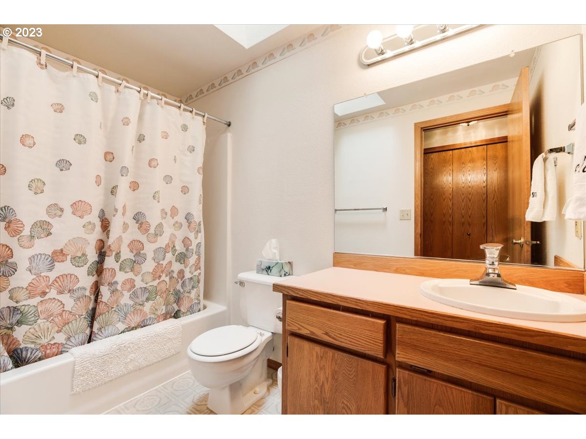 1502 Southeast Elliott Avenue Gresham, OR 97080 - Photo 27 of 37 a bathroom with a sink a toilet and shower curtain