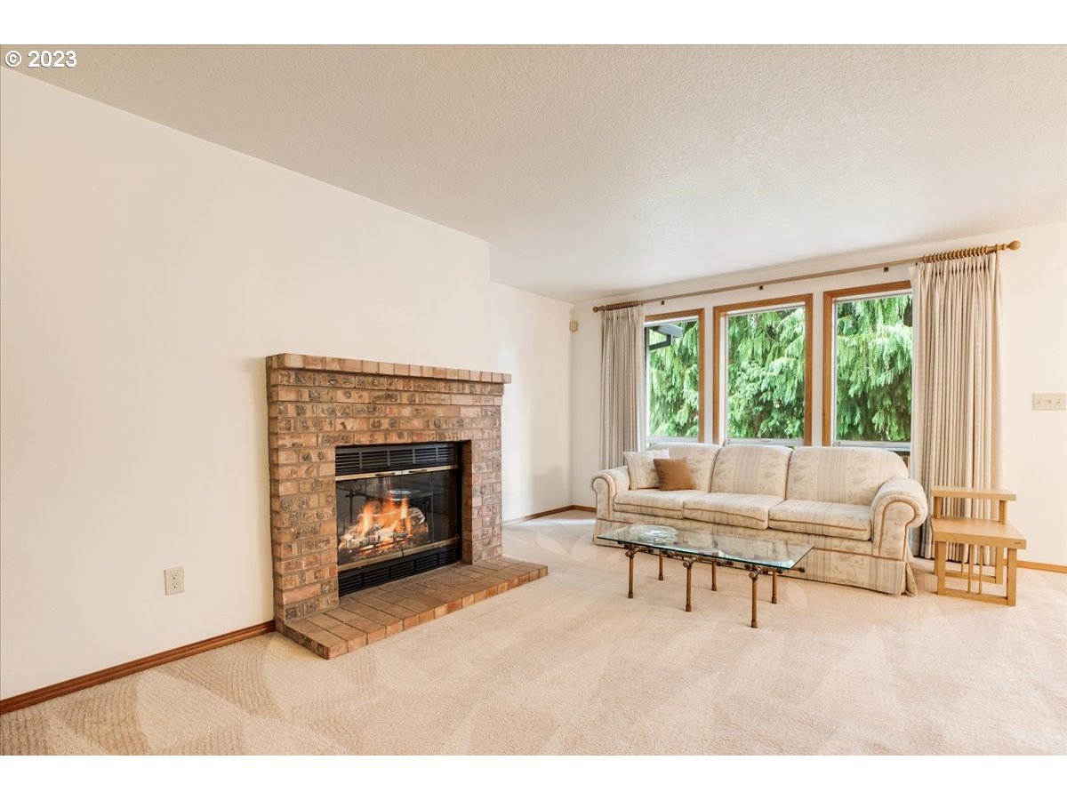 1502 Southeast Elliott Avenue Gresham, OR 97080 - Photo 6 of 37 a living room with a fireplace furniture and a large window