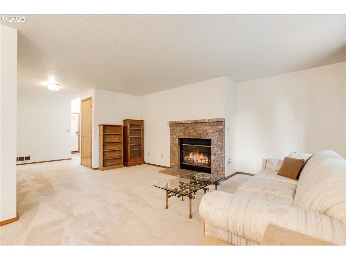 1502 Southeast Elliott Avenue Gresham, OR 97080 - Photo 9 of 37 a living room with furniture and a fireplace