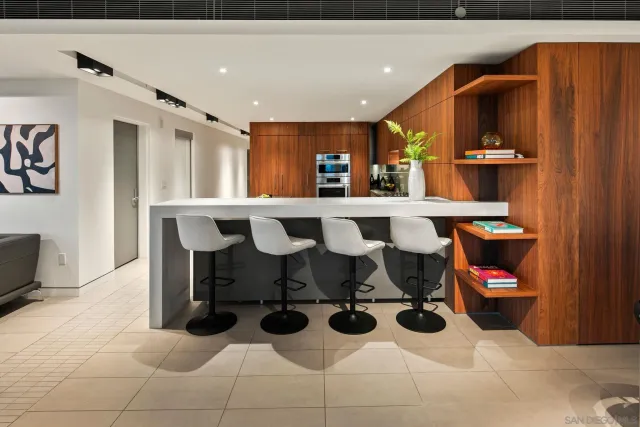 a living room with furniture floor to ceiling window and wooden floor