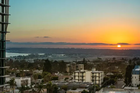 a living room with furniture and a floor to ceiling window