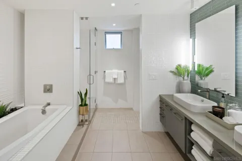 a bathroom with double vanity and a mirror