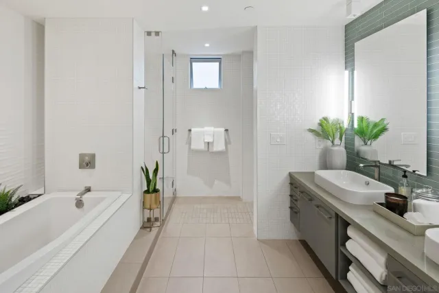 a bathroom with double vanity and a mirror