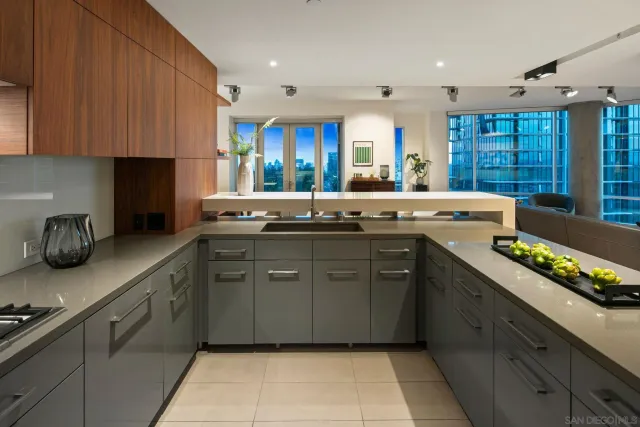 a kitchen with stainless steel appliances granite countertop a sink stove and cabinets