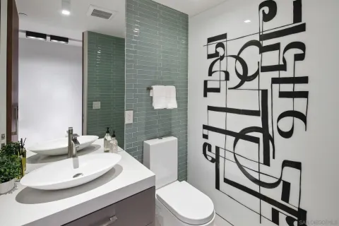 a spacious bedroom with a bed and a mirror